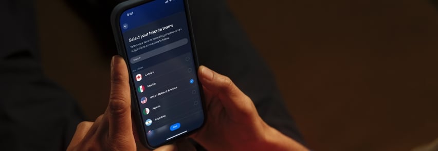 Joukko ystäviä juhlii jalkapallomaalin olohuoneessa dynaamisella punaisella Philips Hue Sports Live -valaistuksella